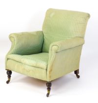 A late 19thC armchair with scrolled arms and raised on turned tapering front legs and block back