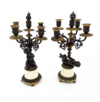 A pair of 19thC five branch candelabra / candelabrum supported by cast cherubs upon marble fluted