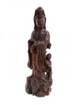 A Chinese carved hardwood model of Guanyin with a child. Approx. 20" high Please Note - we do not