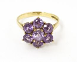 A 9ct gold dress ring set with amethysts. Ring size approx. O Please Note - we do not make reference