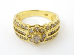 An 18ct gold ring set with diamonds. Ring size approx. M Please Note - we do not make reference to