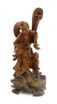 An Oriental carved wooden figural group depicting a fisherman and son. Approx. 10 1/2" high Please