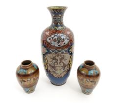 An Oriental cloisonne vase of ovoid form decorated with panels of dragons and Ho Ho birds, scrolling