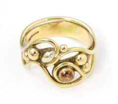 A 9ct gold ring with scrolling detail. Ring size approx. M Please Note - we do not make reference to