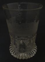 A Continental drinking glass with cut decoration and etched scene depicting a Continental town