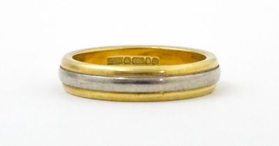 An 18ct yellow gold wedding band with white and rose gold detail. Ring size approx. J Please