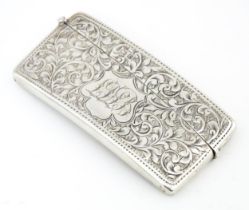 A silver card case with engraved acanthus scroll decoration hallmarked Birmingham 1902, maker