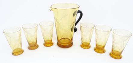 An amber glass lemonade set comprising jug and 6 glasses with foliate decoration lemonade set. the