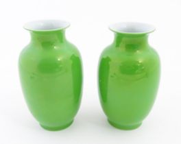 A pair of Chinese vases with green glaze. Character marks under. Approx. 6 1/2" high (2) Please Note