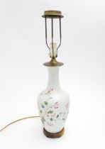 A Chinese ceramic table lamp of vase form decorated with flowers, foliage and insects. Approx. 27