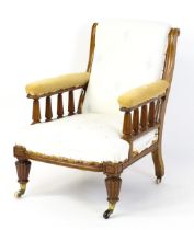 A 19thC armchair for re-upholstery, having a chamfered frame and scrolled back supports above