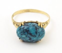 A 9ct gold ring set with turquoise cabochon. Ring size approx. R Please Note - we do not make