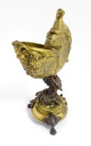 A bronze and ormolu spoon warmer, formed as a nautilus shell with fruiting vine decoration