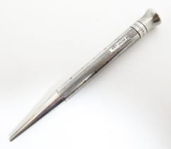 A silver propelling pencil with engine turned decoration titled The Mascot, hallmarked Birmingham