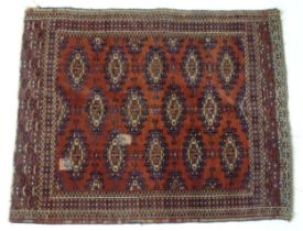 Carpet / Rug : A red ground rug decorated with repeating medallion motifs and geometric borders