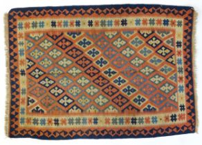 Carpet / Rug : A Persian Qashqai kilim, the terracotta coloured ground decorated with repeating