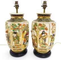 A pair of table lamps with Japanese ceramic vase bases each with figural detail. Approx. 17 1/2"