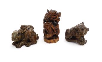 Three Japanese carved hardwood netsukes to include a dragon, a rabbit a with baby on its back, and a