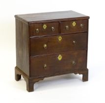 A c.1800 oak chest of drawers of small proportions, the chest comprising two short over two long