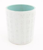 A Chinese brush pot with banded script detail in relief. Character marks under. Approx. 5 1/4"
