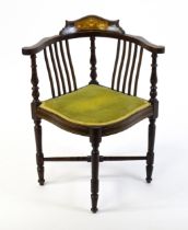 A late 19thC / early 20thC mahogany corner chair with satinwood and boxwood marquetry decoration,