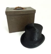 A GA Dunn and Co brushed silk top hat in original case. Head circumference measures 21 1/2"
