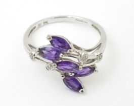 A 9ct white gold ring set with five marquise amethysts in a floral setting. Ring size approx. P