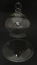 A 19thC glass bell formed cover / cloche with folded foot base. Approx 8 1/2" high Please Note -