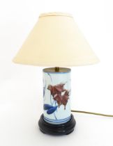 An Oriental ceramic table lamp of cylindrical form decorated with brushwork foliage and Character