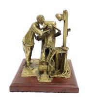 A 20thC brass sculpture depicting dentist and patient, with a wooden base. Approx. 8 3/4" high