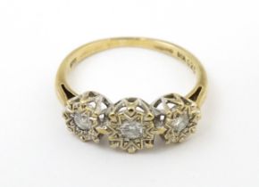 A 9ct gold ring set with three illusion set diamonds. Ring size approx. K 1/2 Please Note - we do