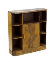 An Art Deco oak bookcase with an open front segmented into seven different sections and having a