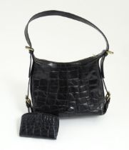 A vintage Mulberry top handle calfskin leather handbag paired with a matching purse. Bag width