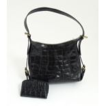 A vintage Mulberry top handle calfskin leather handbag paired with a matching purse. Bag width