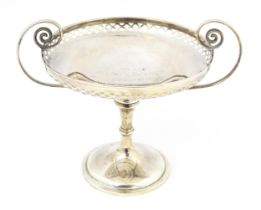 A silver tazza with pierced decoration and scrolling twin handles, hallmarked Sheffield 1911,