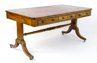 A mid 19thC mahogany library table with a gold tooled leather table top and three frieze drawers