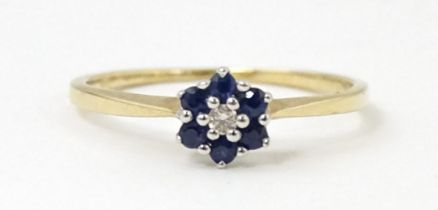 A 9ct gold ring set with central diamonds bordered by blue stones. Ring size approx. I Please Note -