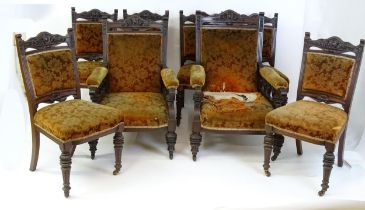 A salon suite / parlour suite of eight late 19thC chairs (6+2), The chairs having carved top rails