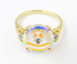 A 9ct gold Lehrer Torus ring set with mystic topaz and diamonds. Ring size approx. N Please Note -