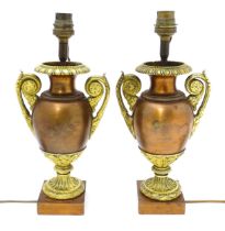 A pair of early to mid 20thC Continental table lamps of twin handled urn form with gilt detail.