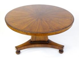 A rosewood breakfast / dining / loo table with a circular egg and dart moulded top above a