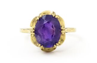 A 9ct gold dress ring set with amethyst. Ring size approx. M 1/2 Please Note - we do not make