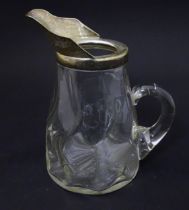 A glass jug with loop handle and silver plate mounts. Approx 7 1/2" high Please Note - we do not