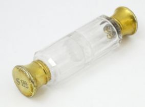 A Victorian glass double ended salts / scents bottle with silver gilt lids, hallmarked London