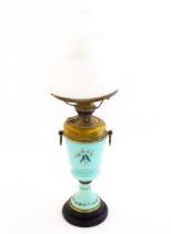 A Victorian oil lamp, the turquoise glass body with hand painted decoration depicting Red