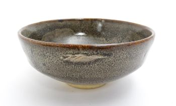 An Oriental bowl with mottled glaze. Impressed Character marks under. Approx. 2 3/4" high x 6"