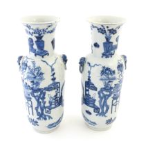 A pair of Chinese blue and white vases with cast lion mask and ring handles, decorated with