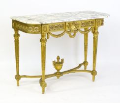 A late 19thC Italian marble topped giltwood table, with a floral pierced frieze, swags bows and four