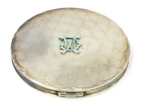 A .925 silver powder compact with engine turned decoration. Approx. 3 1/4" diameter Please Note - we