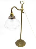 A mid 20thC brass table / students lamp of adjustable height with etched glass shade. Approx. 22"